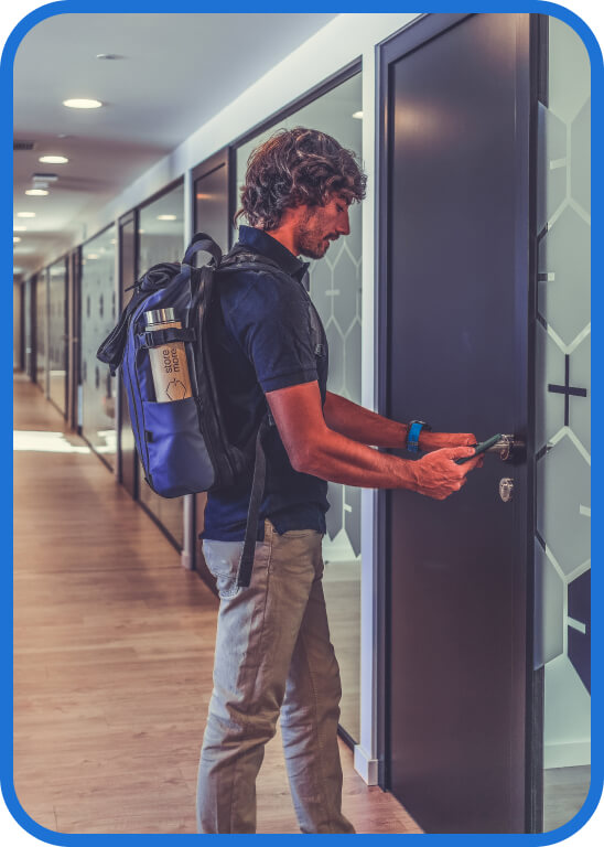 A person unlocking an office door with a smartphone